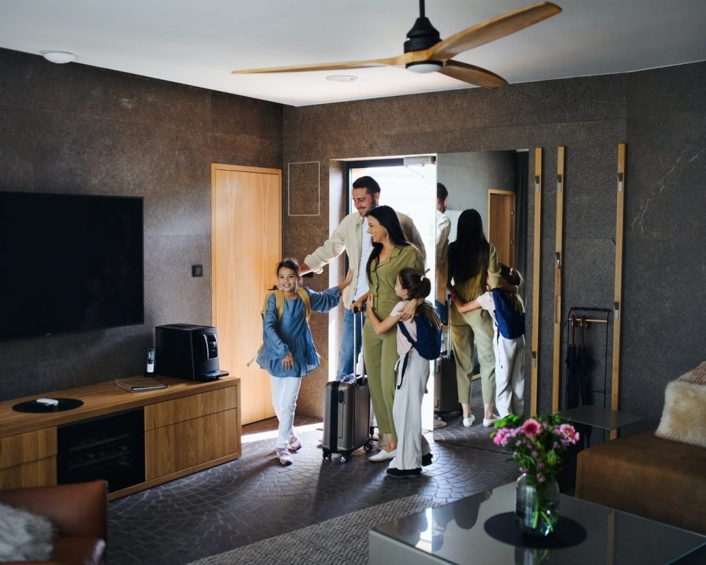happy-young-family-with-two-children-enetring-room-at-luxury-hotel-summer-holiday.jpg
