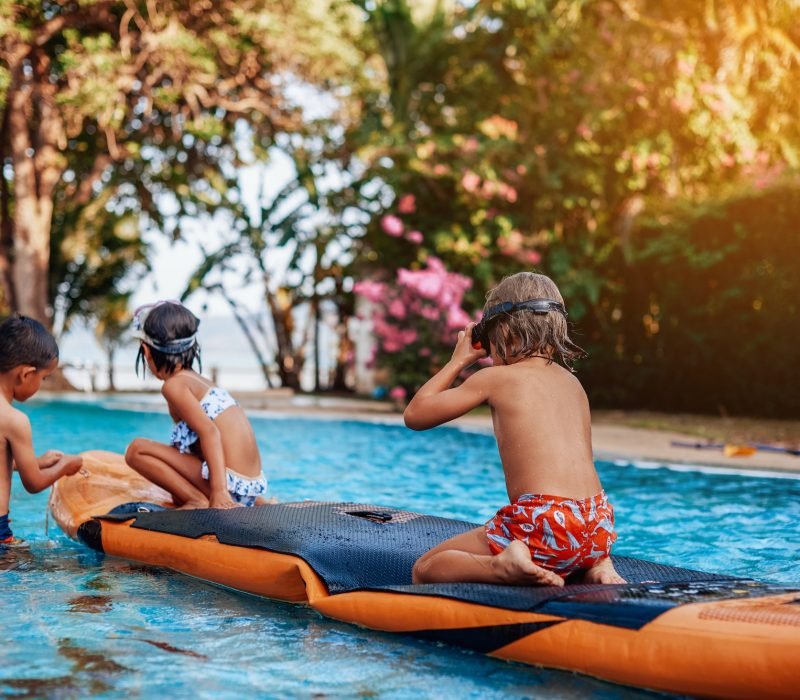 relaxed-children-swim-in-pool-together-with-boat-in-hotel.jpg